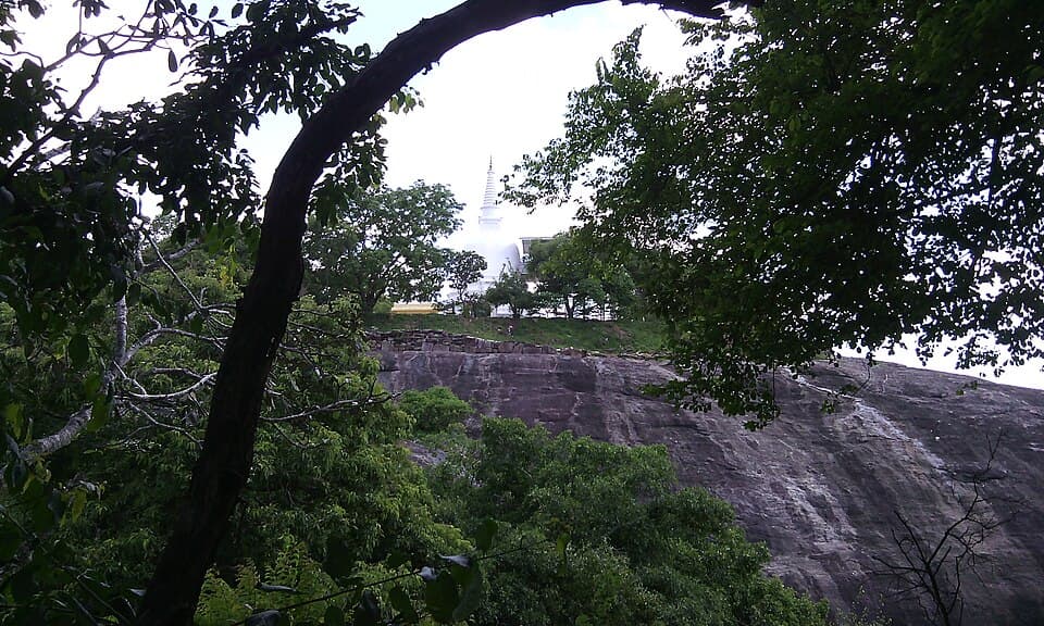 The white stupa of Buddhangala monastery rising above its rock face near Ampara