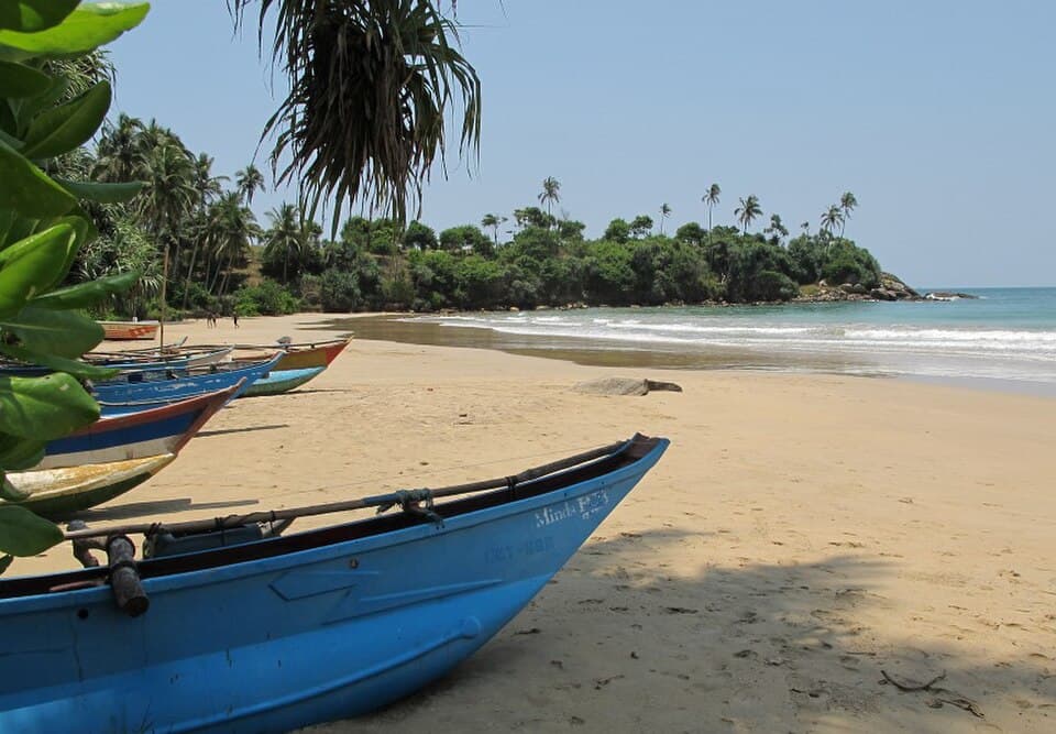 Dickwella Beach with oru canoes drawn up near the Pehambiya headland