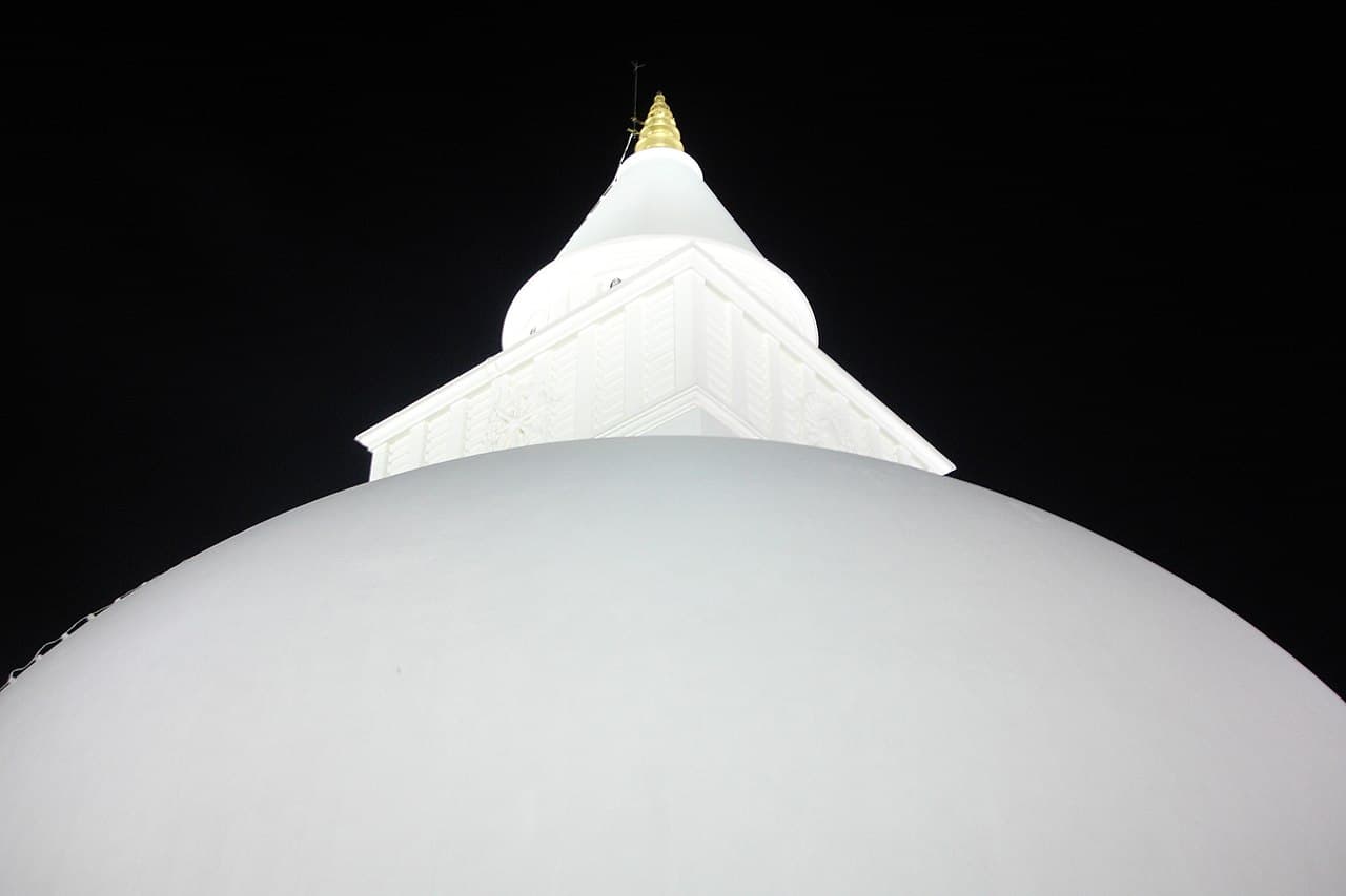 The white dome and pinnacle of Kiri Vehera at Kataragama, lit at night