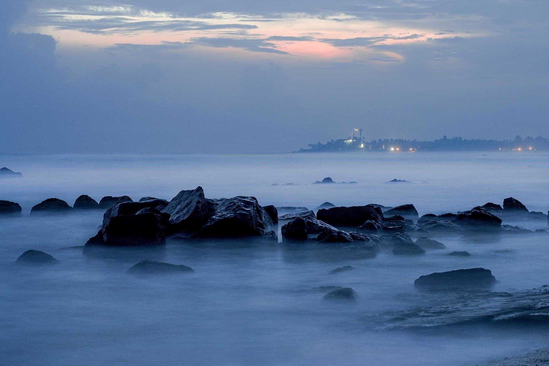 Rocks off Madiha Beach at dusk, on Sri Lanka's southern coast near Matara
