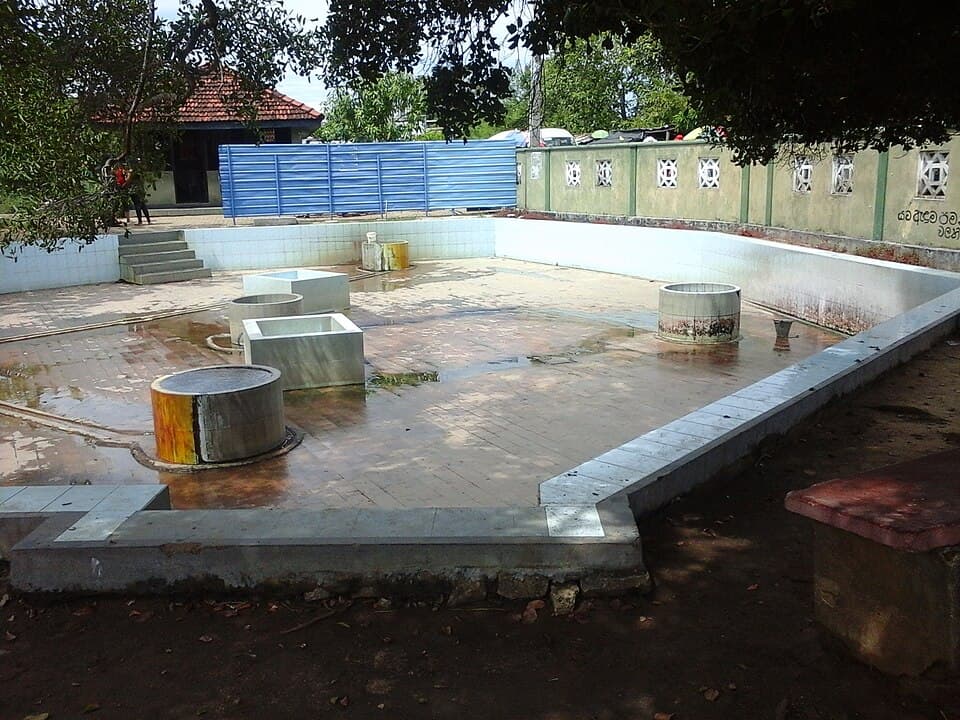 The tiled enclosure and round wells of the Maha Oya hot springs