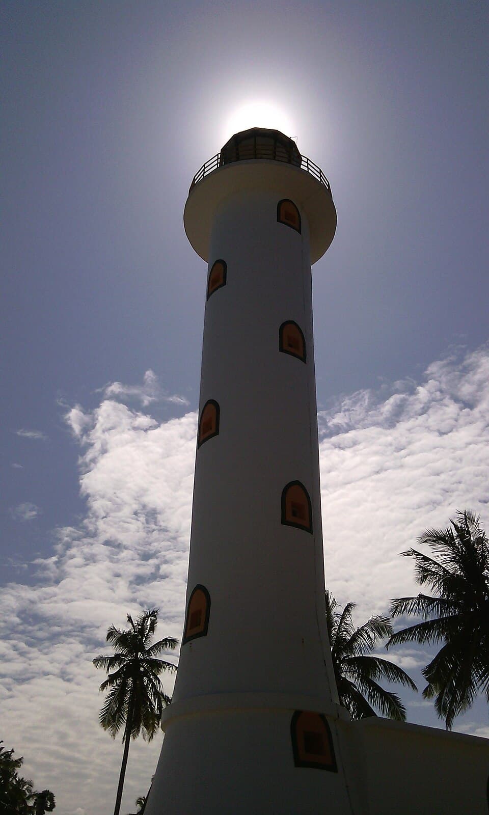 The white concrete tower of Oluvil Lighthouse against the sky