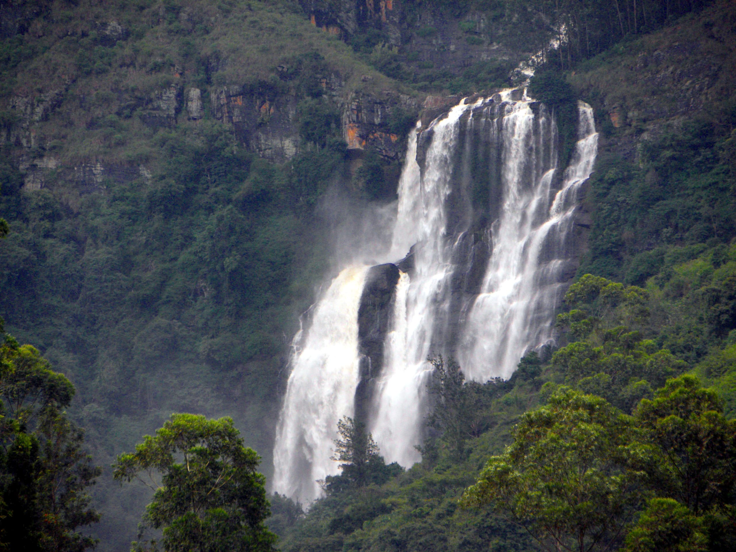 Bomburu Ella waterfall cascading across a rocky cliff in the Nuwara Eliya hills