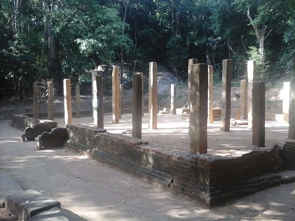 Stone pillars of a ruined building in the forest at Rajagala, Ampara