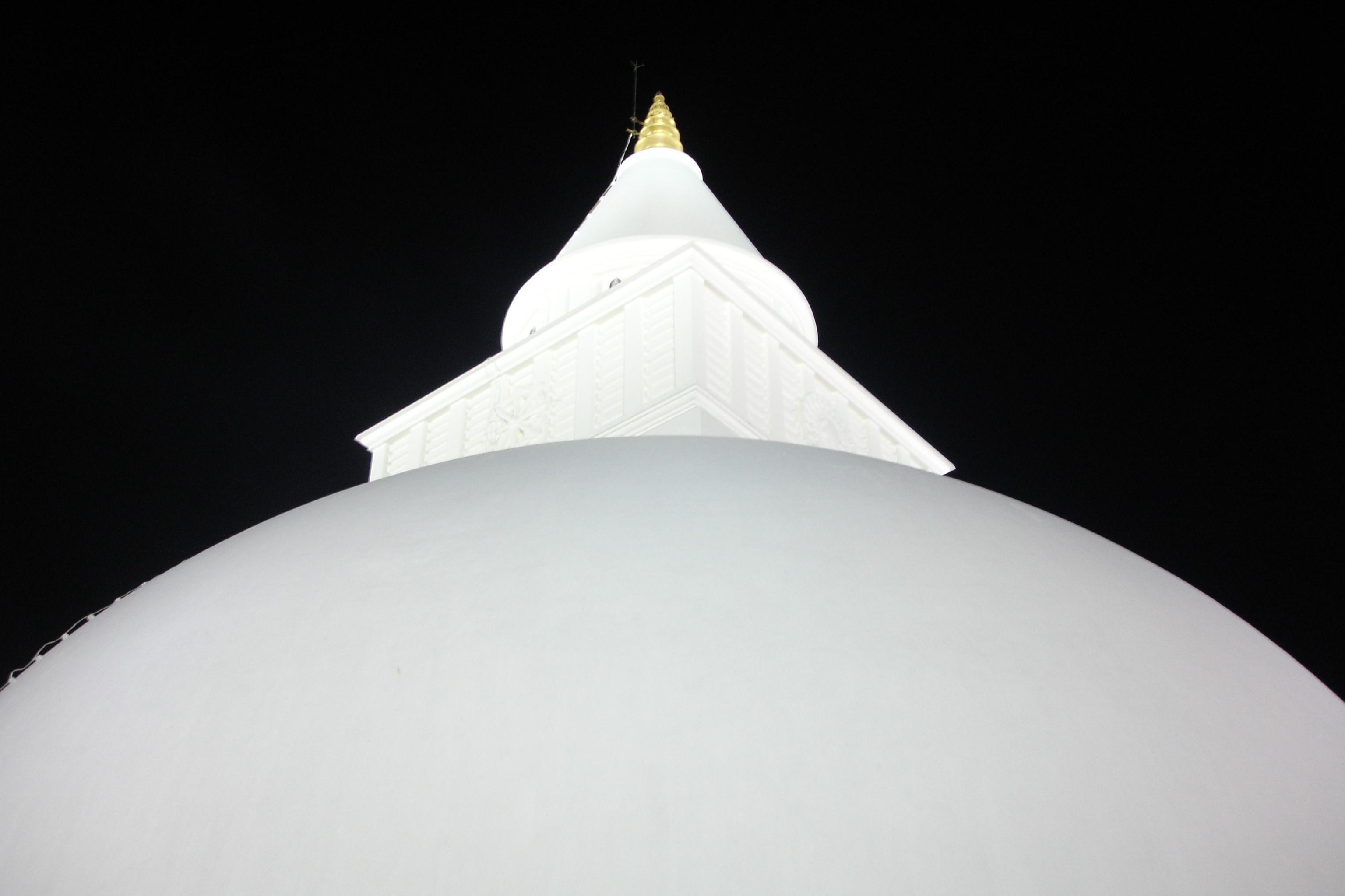 The white dome and pinnacle of Kiri Vehera at Kataragama, lit at night